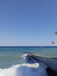 Scenic view of sea against clear blue sky