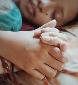 Close-up of woman lying on bed