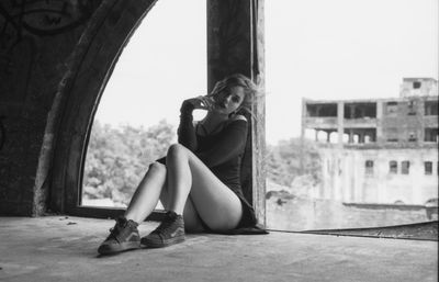 Full length of woman sitting against clear sky