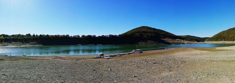Scenic view of lake against clear blue sky