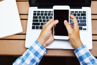 High angle view of person using laptop on table