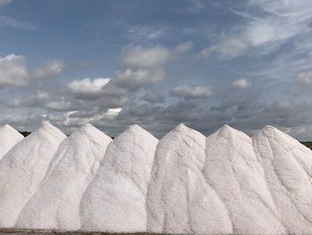 Low angle view of white rocks against sky