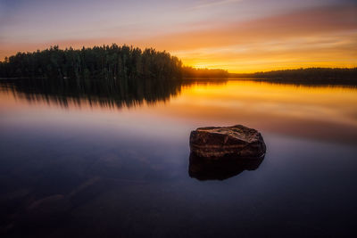 Scenic view of calm lake at sunset