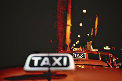 Close-up of road sign at night