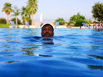 Portrait of man swimming in pool