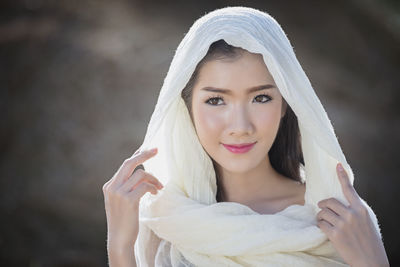 Portrait of a smiling young woman standing outdoors