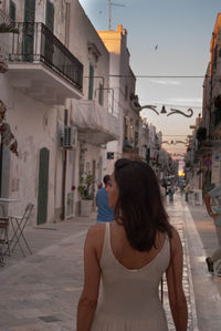 Rear view of walking on street in city