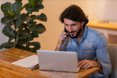 Young business man working with laptop. gray notebook for working. home office . 