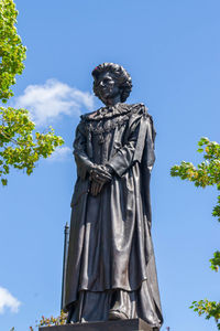 Low angle view of statue against blue sky