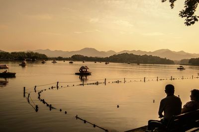 Scenic view of lake at sunset