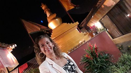 Portrait of smiling young woman at night