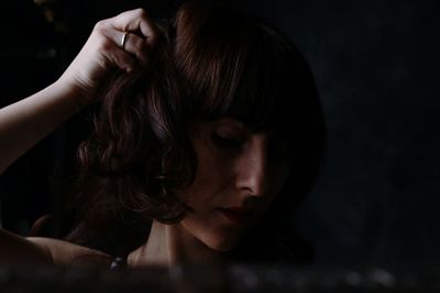 Close-up of beautiful woman with hand in hair