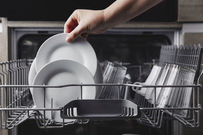 Cropped hand of man preparing food on table