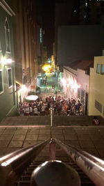 People on illuminated street at night