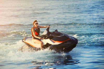 Woman jet boating in sea