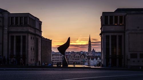 Buildings in city at sunset