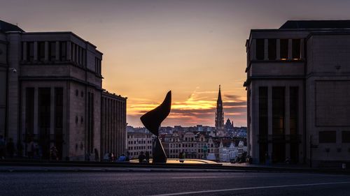 Buildings in city at sunset