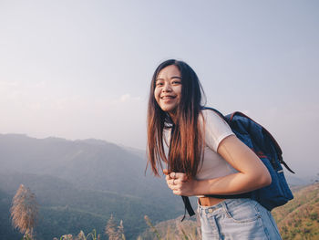 Wanderlust and travel concept from happy asian young woman walking trail in mountain