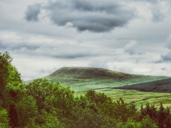 Scenic view of mountains against cloudy sky