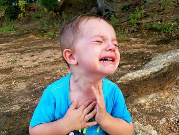 Close-up of boy crying outdoors