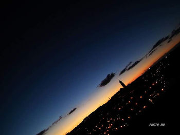 Silhouette mountain against sky at night