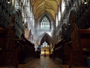 Rear view of person standing in front of church altar