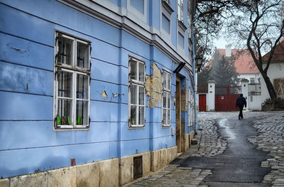 Abandoned building by alley