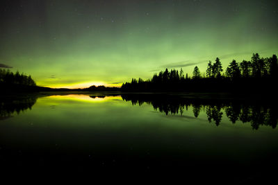 Scenic view of lake against sky at night