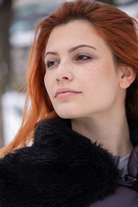 Close-up of redhead woman looking away