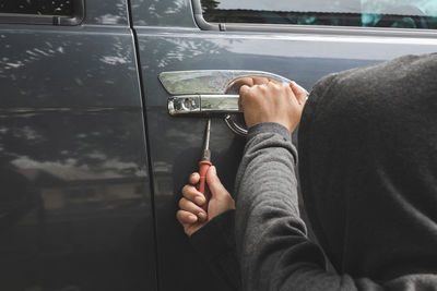 Burglar breaking car door