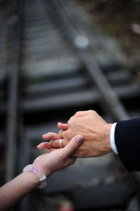 Close up of  newly wed couple holding hands