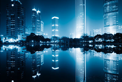 Reflection of illuminated buildings in river at night