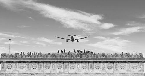 Low angle view of airplane flying in sky