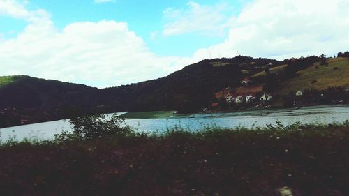 Scenic view of lake against cloudy sky