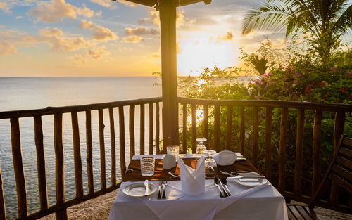 Empty chairs and tables at beach