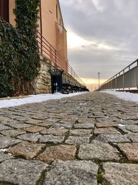 Walkway by building against sky