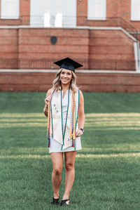 Portrait of a smiling girl standing on grass