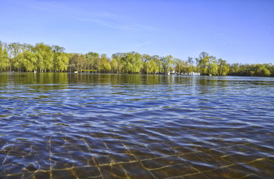 Scenic view of lake against blue sky