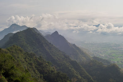 Scenic view of mountains against cloudy sky