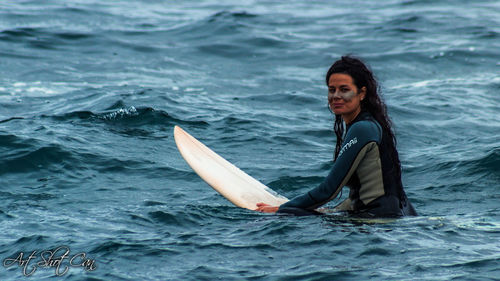 Portrait of young woman swimming in sea