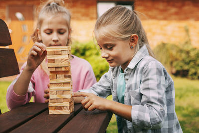 Portrait of mother and girl playing on table