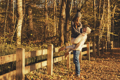 Rear view of woman standing in forest