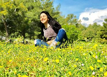 Portrait of a smiling young woman on field