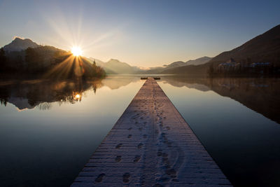 Scenic view of lake against sky during sunset