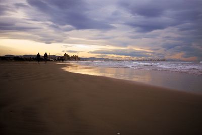 Scenic view of beach against sky during sunset