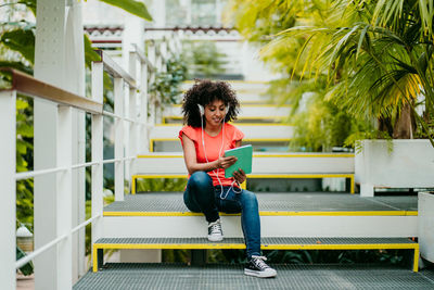 Portrait of young woman sitting on bench