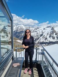 Full length of woman standing against snowcapped mountain range