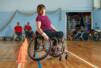 Young woman riding bicycle on floor