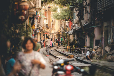 People on railroad tracks in city