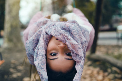 Portrait of shocked girl leaning in forest